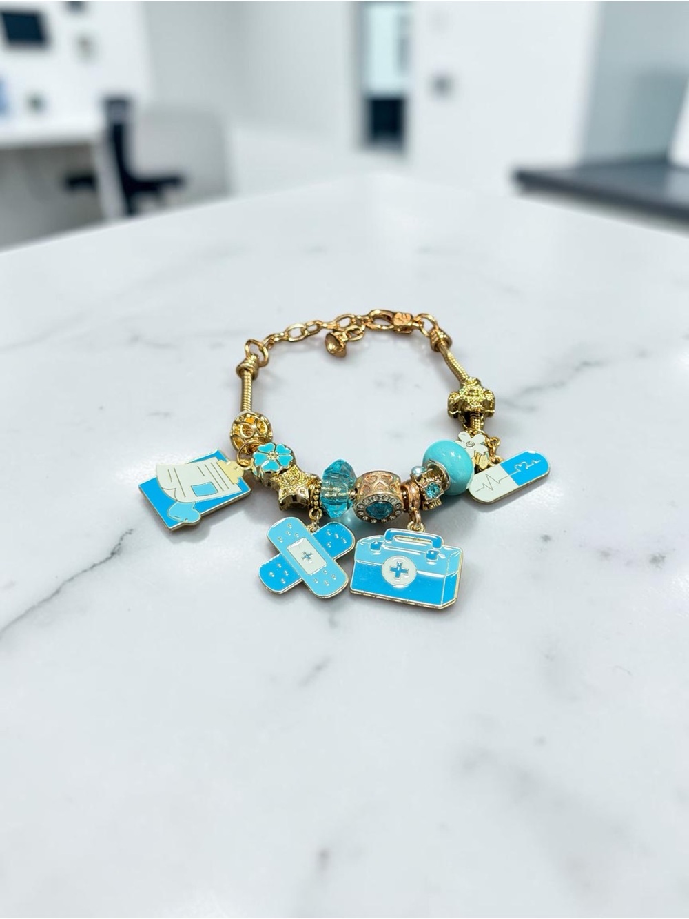 Gold-Tone Charm Bracelet with Turquoise Blue Medical Charms